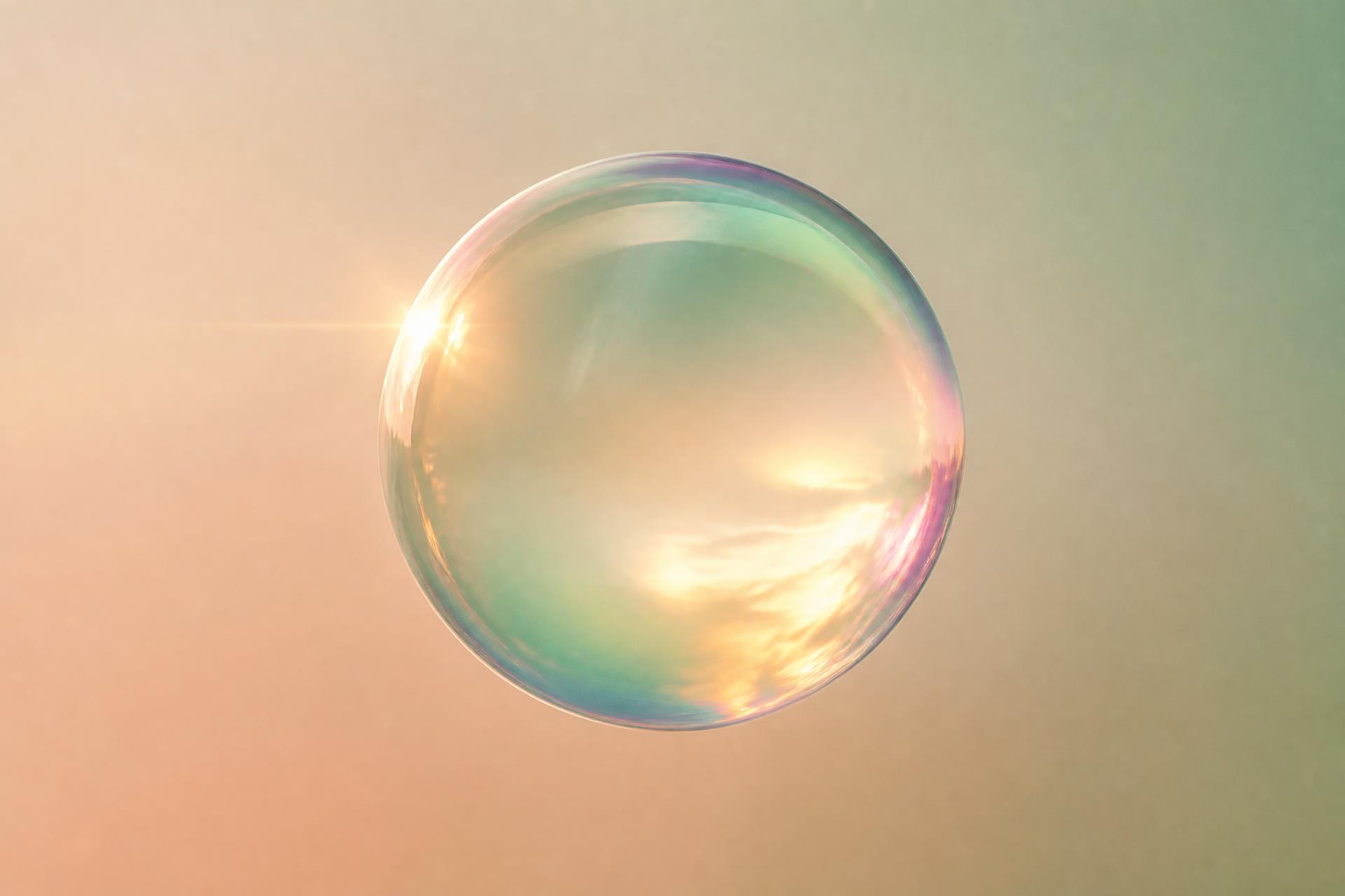 Iridescent glass orb over a warm peach and sage gradient
